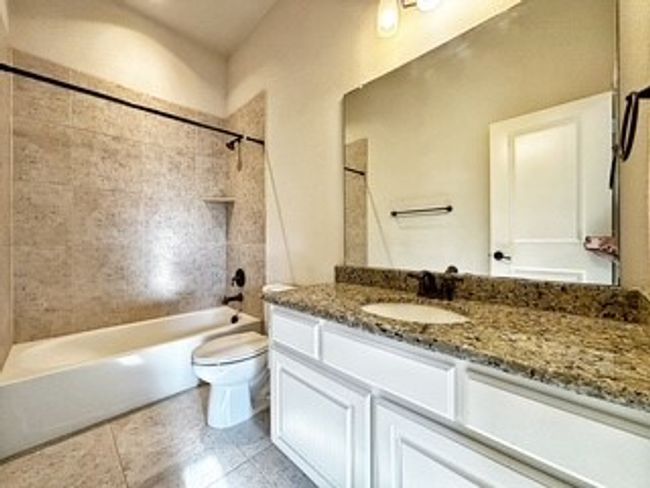 Bathroom featuring shower / bath combination, vanity, and tile patterned flooring | Image 17