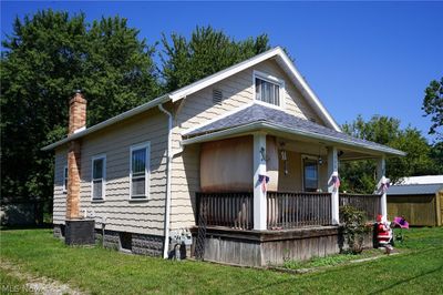 View of front of house with cooling unit, and a front yard | Image 2