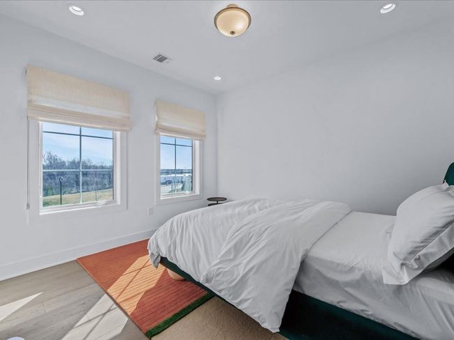Bedroom with baseboards, visible vents, wood finished floors, and recessed lighting | Image 16
