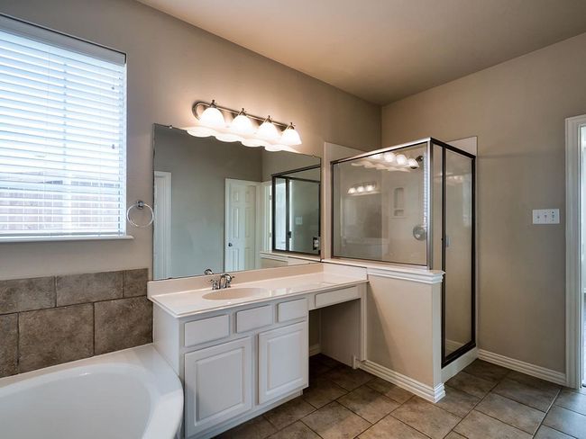 Full bathroom with a shower stall, vanity, tile patterned flooring, and a garden tub | Image 31