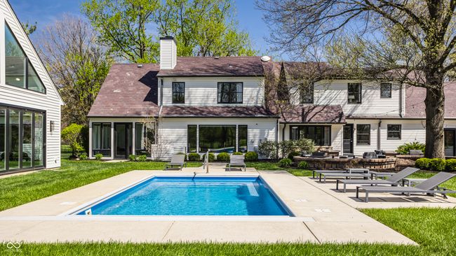 rear view of house with a lawn, a patio, an outdoor pool | Image 64