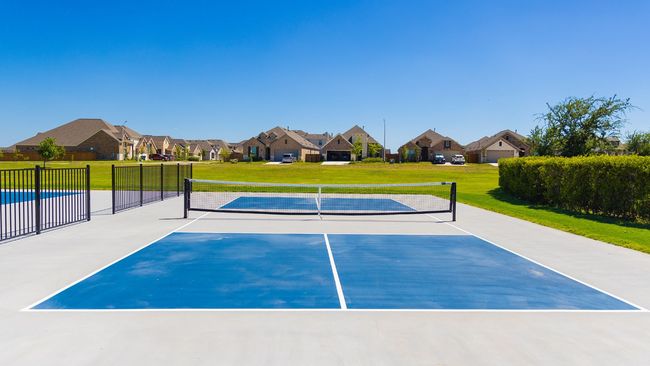 View of sport court featuring a lawn, fence, and a residential view | Image 13
