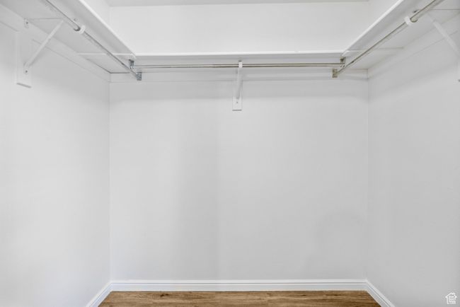 Spacious closet with wood finished floors | Image 19