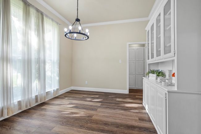 The formal dining has tall windows, natural light and connects to the kitchen. | Image 4
