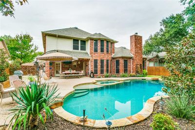 View of swimming pool with a patio area and an in ground hot tub | Image 2