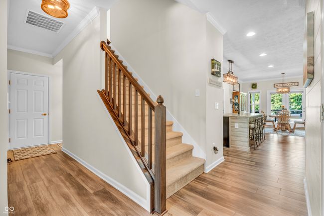 staircase with crown molding leads to spacious bonus room w/full bath | Image 6