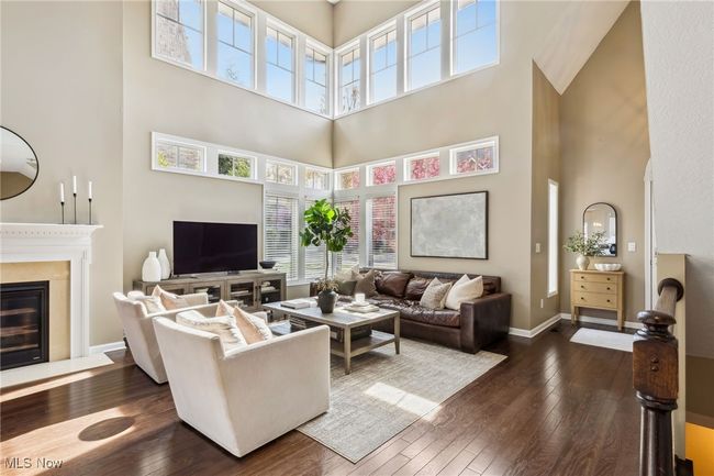 A closer look at the living area, featuring the fireplace and bright, open feel | Image 6