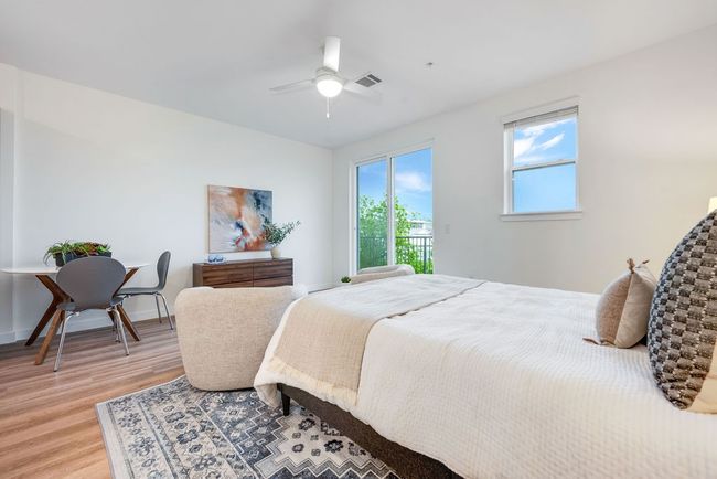 Bedroom with light wood-style floors and a ceiling fan | Image 13