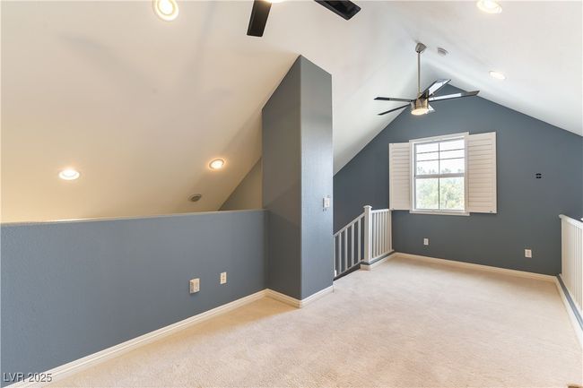 Additional living space featuring baseboards, carpet floors, lofted ceiling, and a ceiling fan | Image 32