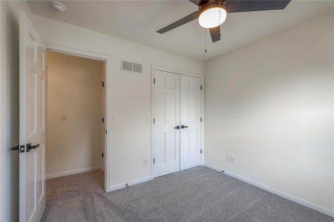 Unfurnished bedroom featuring carpet, a closet, and ceiling fan | Image 19