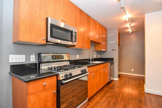 Kitchen featuring a gas stove and oven, surrounded by sleek cabinetry offering plenty of storage. | Image 18