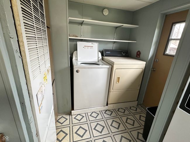 washroom with independent washer and dryer, laundry area, a heating unit, and light floors | Image 30