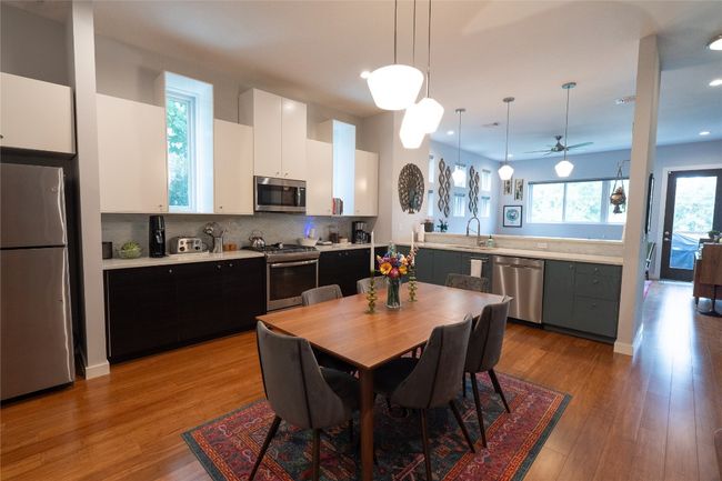 Kitchen featuring appliances with stainless steel finishes, light countertops, white cabinets, tasteful backsplash, and recessed lighting | Image 24