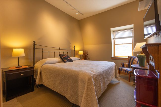 Bedroom with carpet floors, track lighting, and lofted ceiling | Image 13