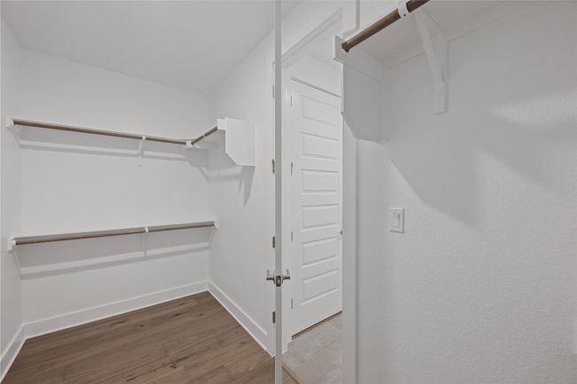 Spacious closet with wood finished floors | Image 18