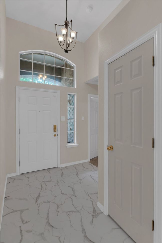 Foyer entrance with a chandelier and light marble finish floors | Image 8