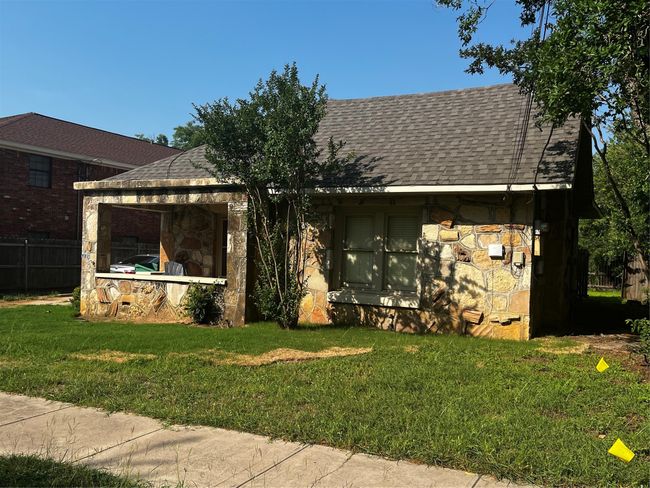 View of front facade with roof with shingles and stone siding | Image 21