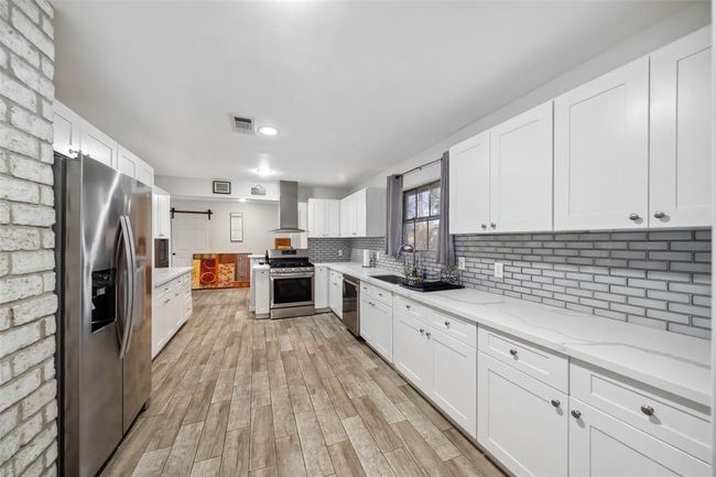 ROOMY KITCHEN WITH RECENT (LAST FEW YEARS) STAINLESS UPGRADES W SUBWAY TILE BACKSPLASH. NICE NATURAL LIGHTING COMING FROM THE PERFECTLY PLACED WINDOW | Image 13