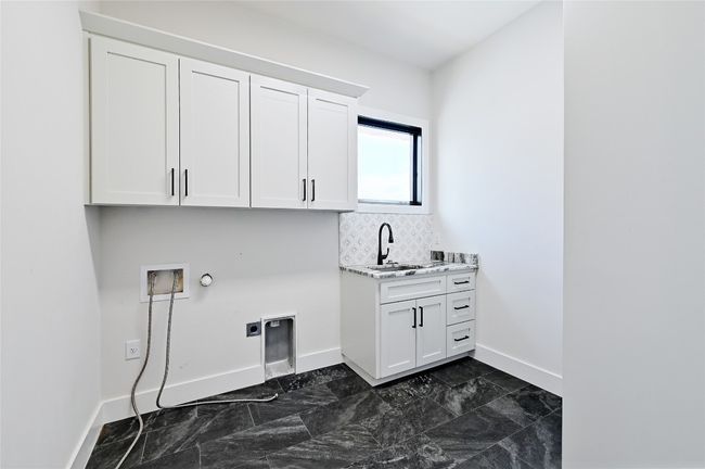 Laundry area with hookup for a washing machine, baseboards, cabinet space, electric dryer hookup, and hookup for a gas dryer | Image 31