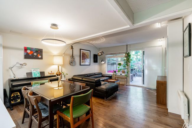 Dining room with hardwood / wood-style flooring and radiator heating unit | Image 11