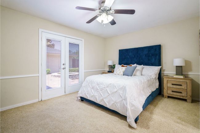 Guest bedroom featuring french door access to backyard | Image 26
