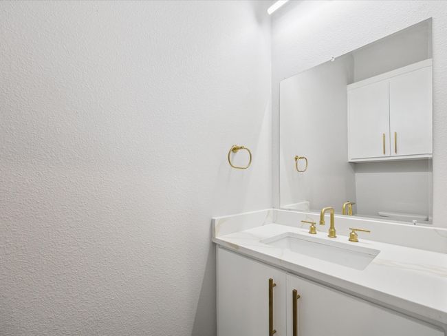 Bathroom with vanity and a textured wall | Image 25