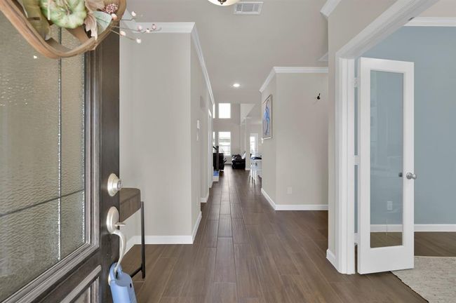 You've arrived... and are immediately greeted with wood-look tile, a neutral color palette, and a view straight back to the heart of the home and an impressive open layout. | Image 4