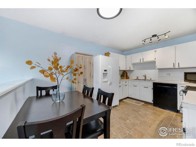 Spacious, bright, open eat-in kitchen has updated light fixtures. | Image 13