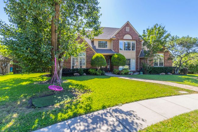 Traditional-style house with a front lawn, brick siding, and a shingled roof | Image 30