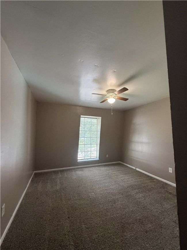 Unfurnished room featuring carpet and a ceiling fan | Image 6