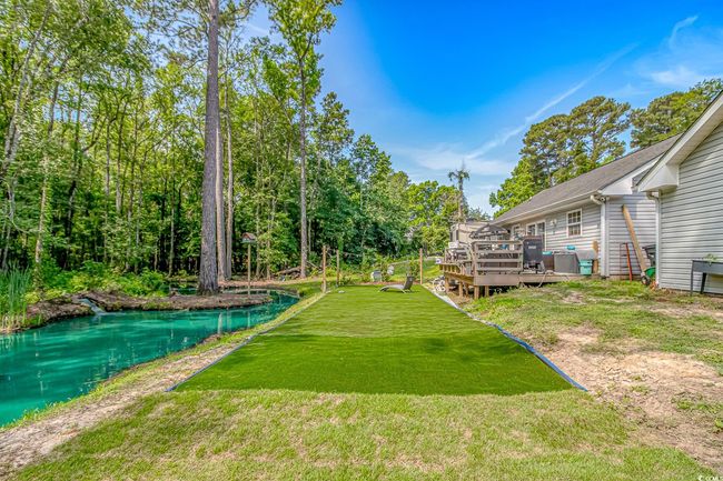 View of green lawn featuring a wooden deck | Image 30