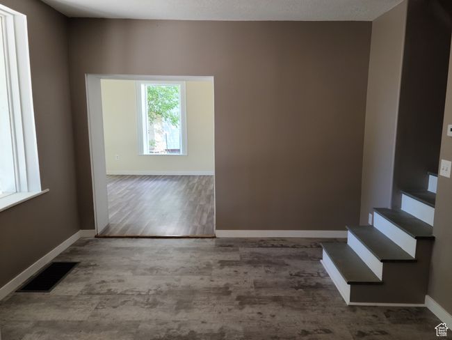 Unfurnished room with baseboards, wood finished floors, and stairway | Image 20