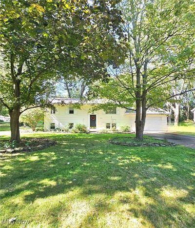 View of front facade featuring a front lawn and a garage | Image 3