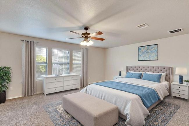Carpeted bedroom featuring a ceiling fan and baseboards | Image 40