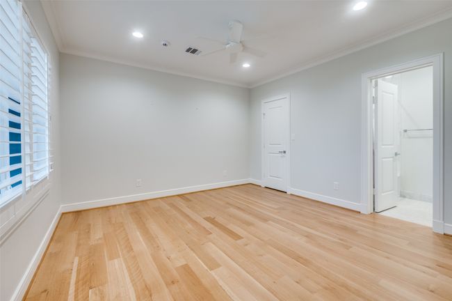 Spare room featuring light wood finished floors, ornamental molding, visible vents, ceiling fan, and recessed lighting | Image 24