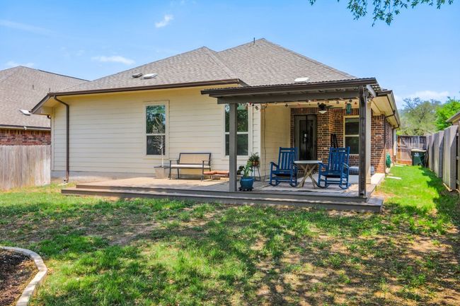 Rear view of property with a lawn, a fenced backyard, and a wooden deck | Image 29