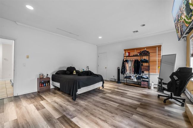 Bedroom featuring crown molding, visible vents, recessed lighting, and wood finished floors | Image 18
