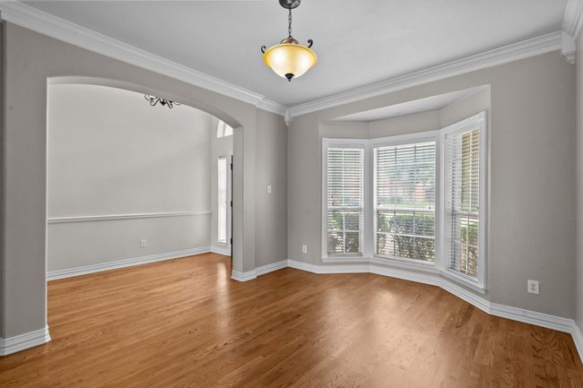 Dining room with gracious windows and stately wood floors | Image 5