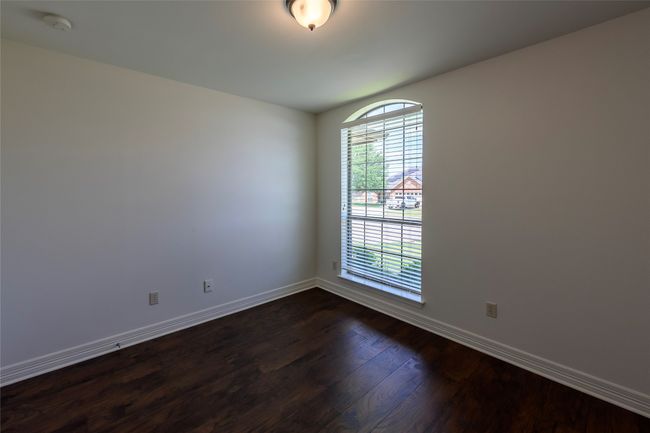 Empty room with baseboards and dark wood-style flooring | Image 29