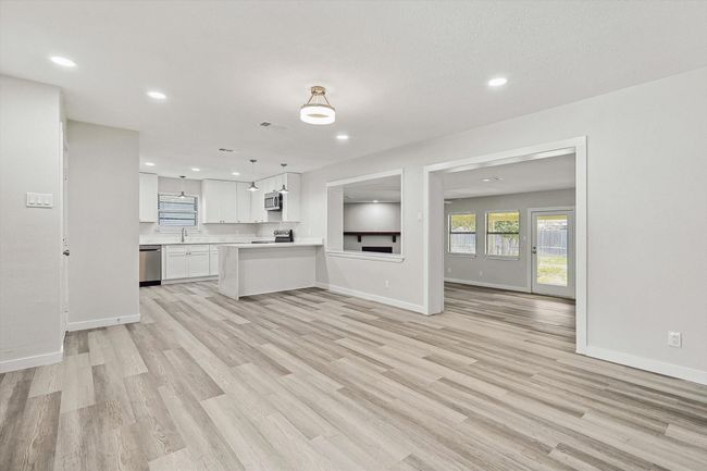 Unfurnished living room featuring recessed lighting, light wood-style flooring, and baseboards | Image 12