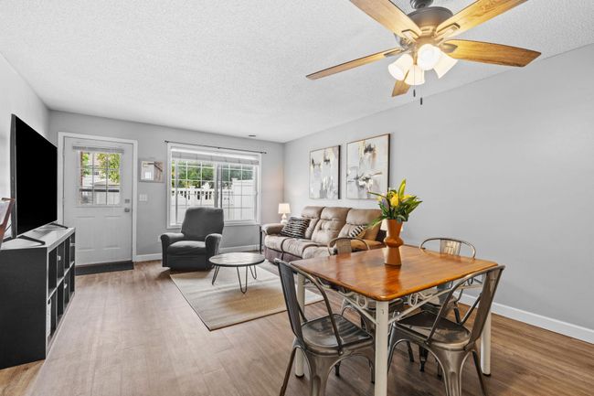 Spacious main level living with large windows that bring in plenty of natural light. | Image 7
