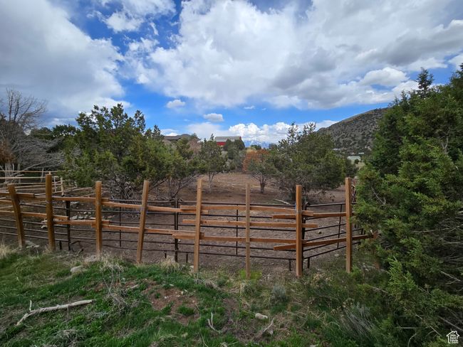 View of gate with a mountain view and fence | Image 7