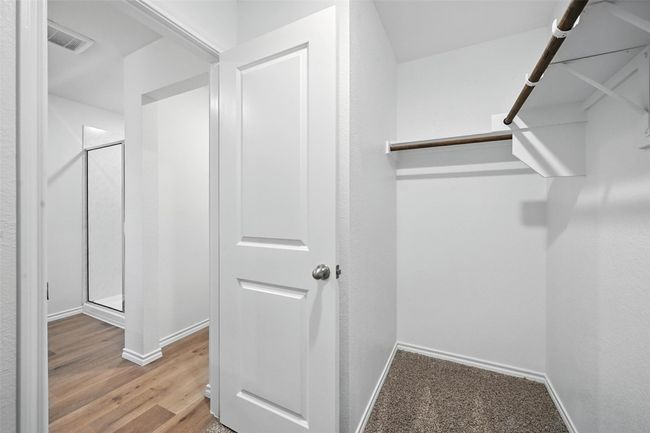 Walk in closet with wood finished floors | Image 16