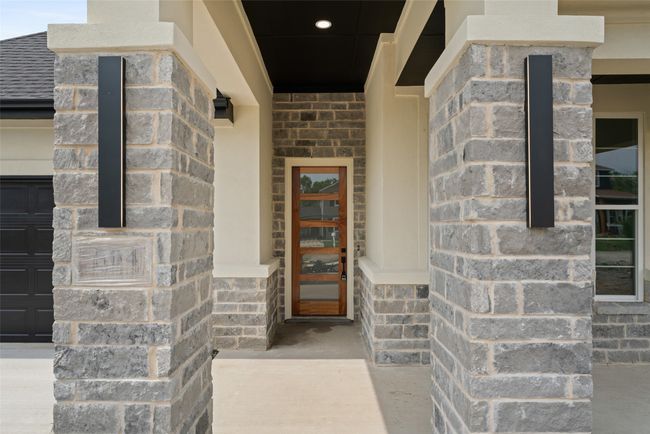 Doorway to property featuring stone siding | Image 4