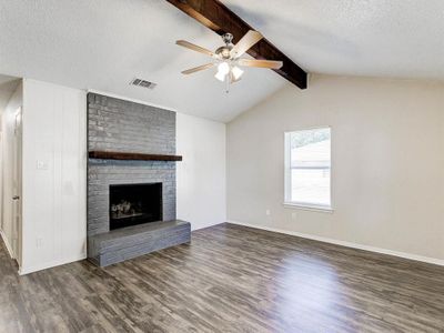 Lofted Ceiling with beam, Ceiling fan, neutral paint tones | Image 2