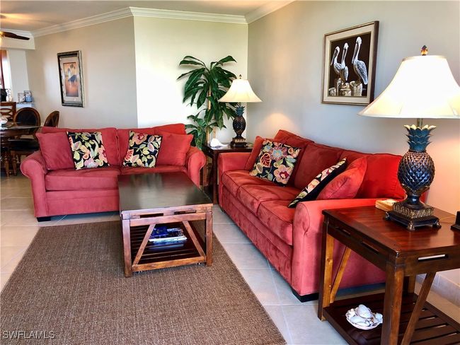 Living room with tile patterned floors and ornamental molding | Image 9