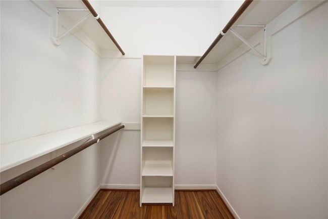 Large walk-in closet offering ample space for clothing and personal storage needs. | Image 31