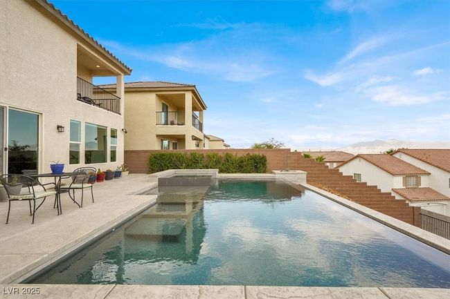 View of pool with a patio and a pool with connected hot tub | Image 60