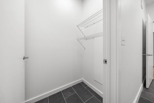 Washroom featuring baseboards and dark tile patterned floors | Image 9