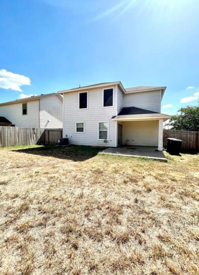 Rear view of property featuring a fenced backyard, a patio area, and central AC unit | Image 18